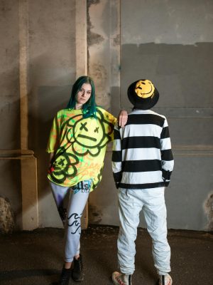 Edgy street fashion featuring vibrant graffiti designs in an urban setting.