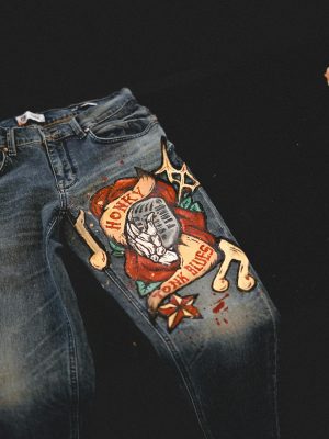 Explore this unique pair of jeans featuring a hand-painted artistic design, perfect for fashion enthusiasts.