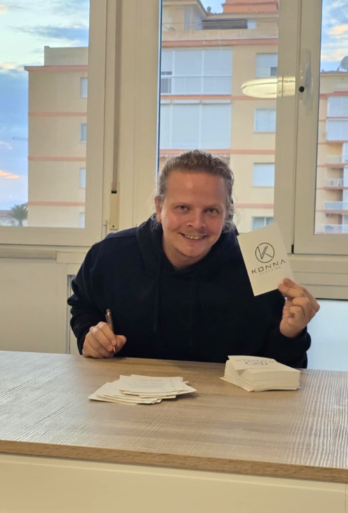 signing Konna Clothing cards, working on early brand development.